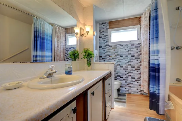 a bathroom with a sink a vanity and a mirror