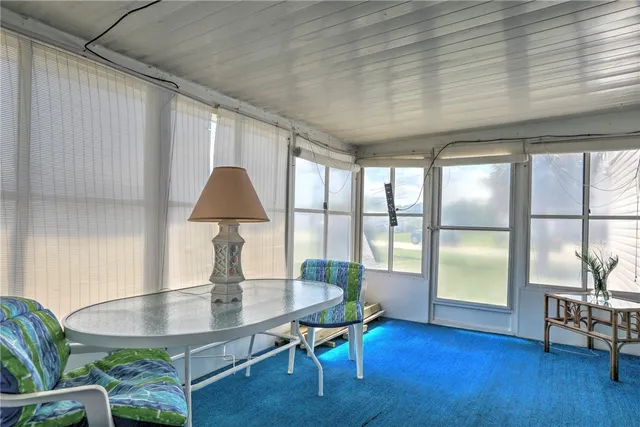a living room with furniture a table and a potted plant