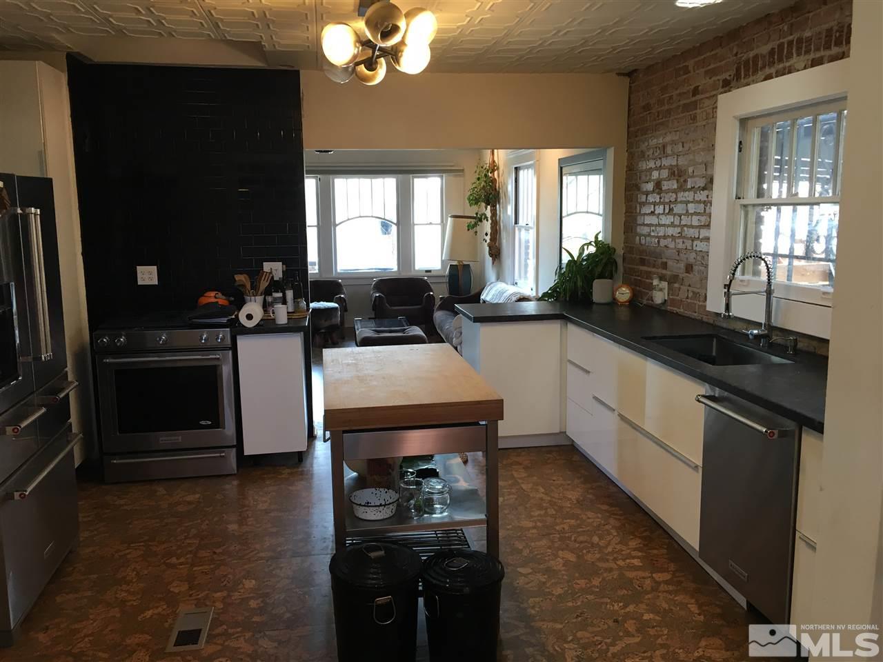 429 Burns Street Reno, NV 89502 - Photo 3 of 12 a kitchen with a sink stainless steel appliances and cabinets