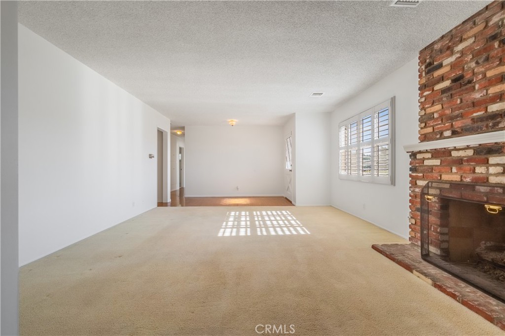 1355 East Level Street Covina, CA 91724 - Photo 6 of 30 a view of an empty room with a fireplace and a window
