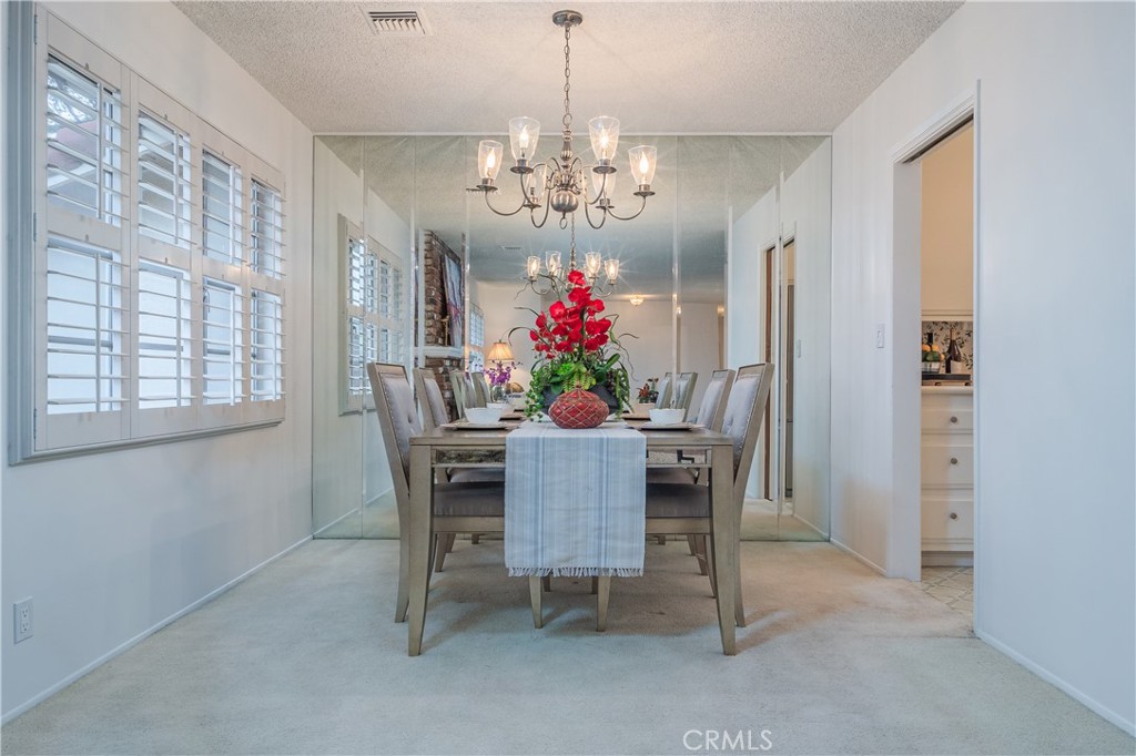 1355 East Level Street Covina, CA 91724 - Photo 8 of 31 a view of a dining room with furniture a chandelier and a window