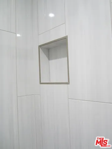 a bathroom with a shower a sink a toilet and mirror