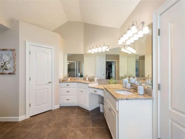 a large kitchen with a lot of counter space and wooden floor