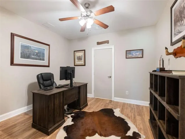 a view of a workspace with furniture and a window