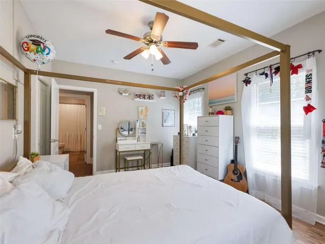 a bedroom with a bed and a large mirror with a flat tv screen