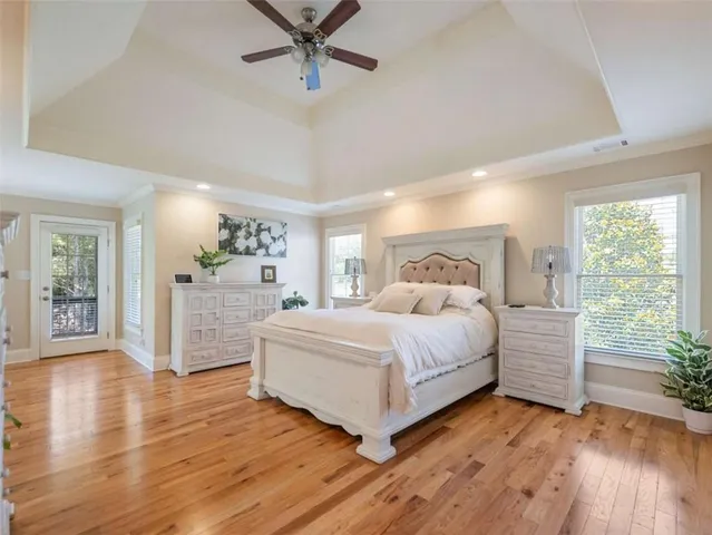 a bedroom with a large bed and a chandelier