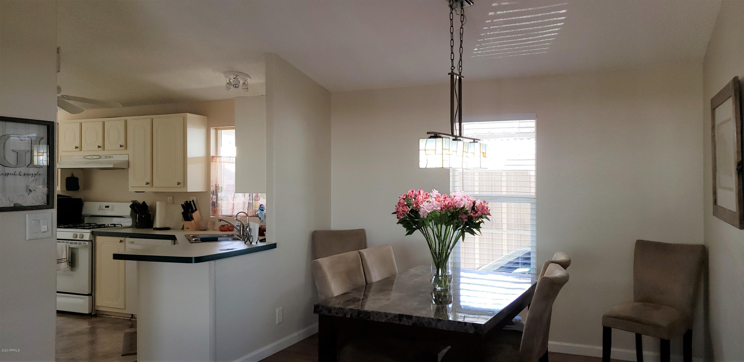 301 South Signal Butte Road, Unit 705 Apache Junction, AZ 85120 - Photo 11 of 50 a dining room with furniture and window