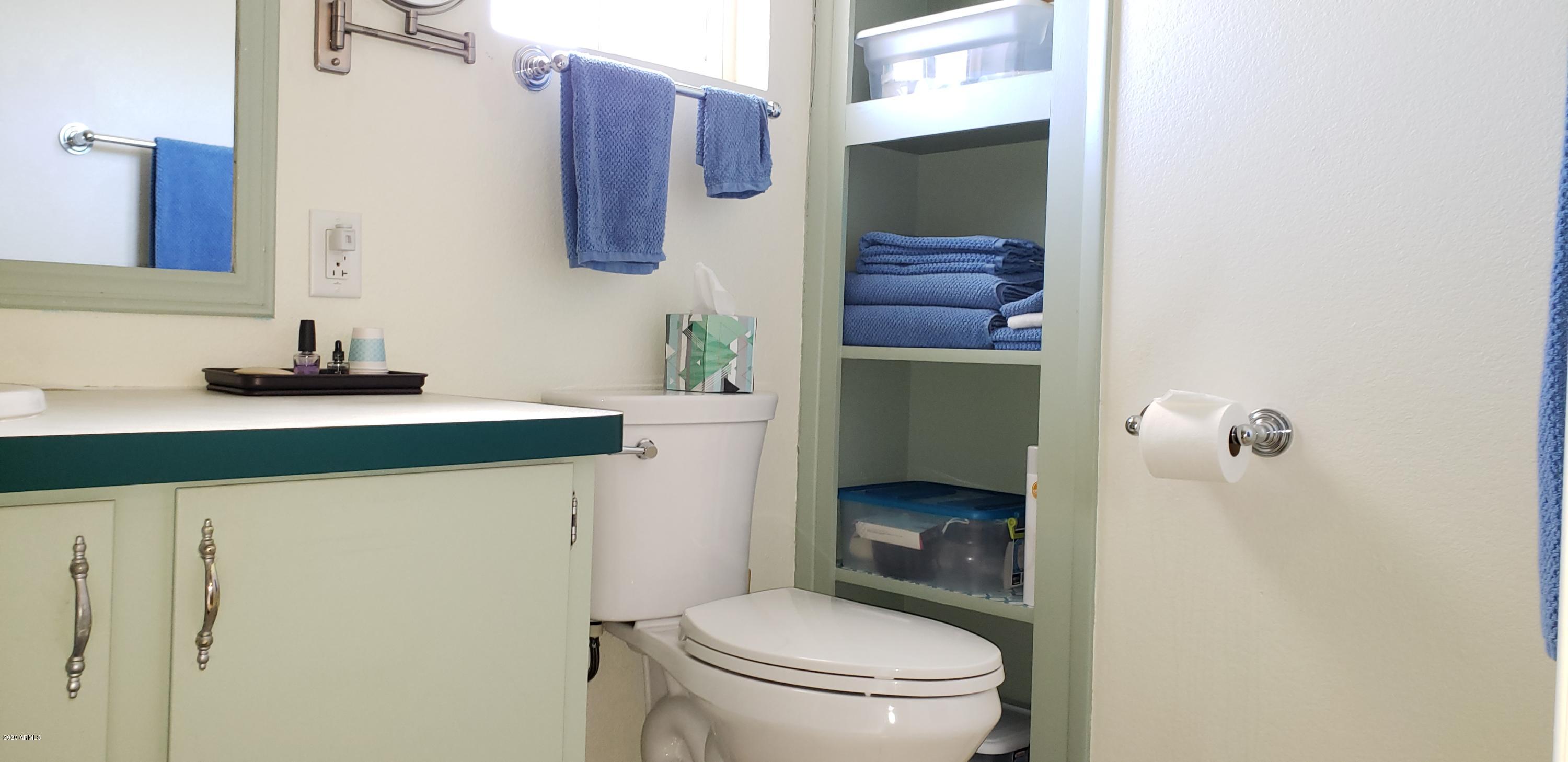 301 South Signal Butte Road, Unit 705 Apache Junction, AZ 85120 - Photo 22 of 50 a bathroom with a granite countertop toilet sink and mirror