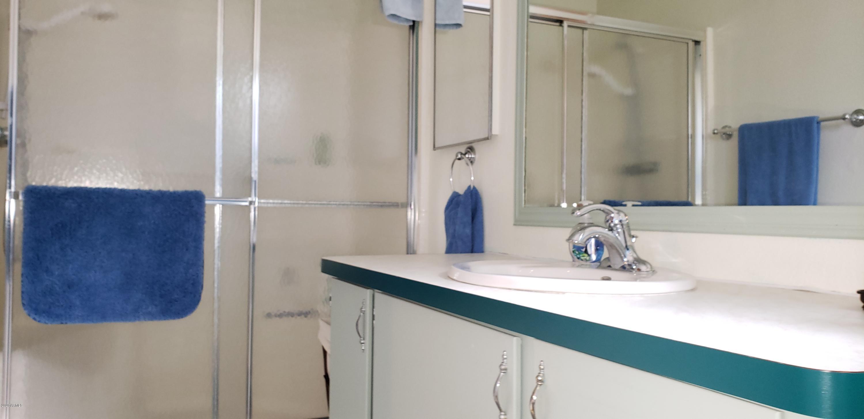 301 South Signal Butte Road, Unit 705 Apache Junction, AZ 85120 - Photo 23 of 50 a bathroom with a sink and a mirror