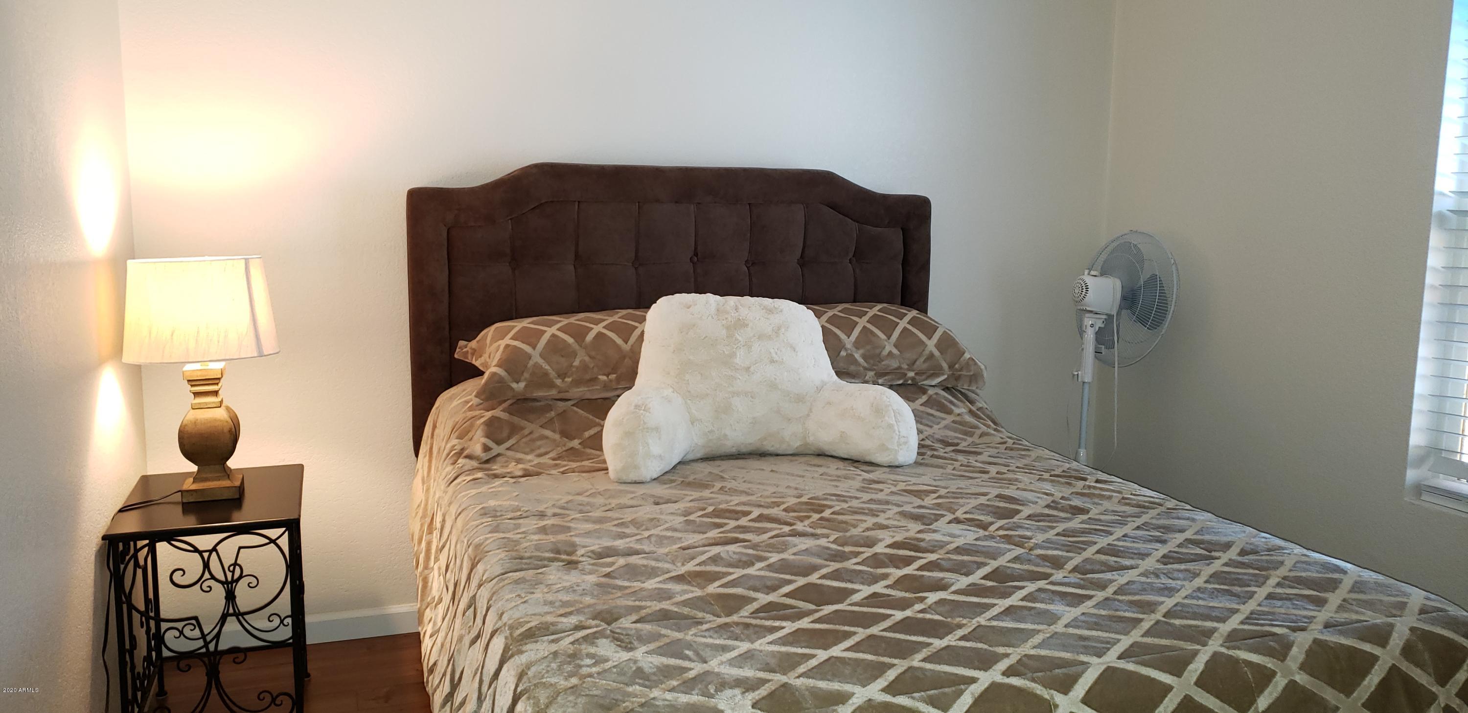 301 South Signal Butte Road, Unit 705 Apache Junction, AZ 85120 - Photo 26 of 50 a bedroom with a bed and wooden floor