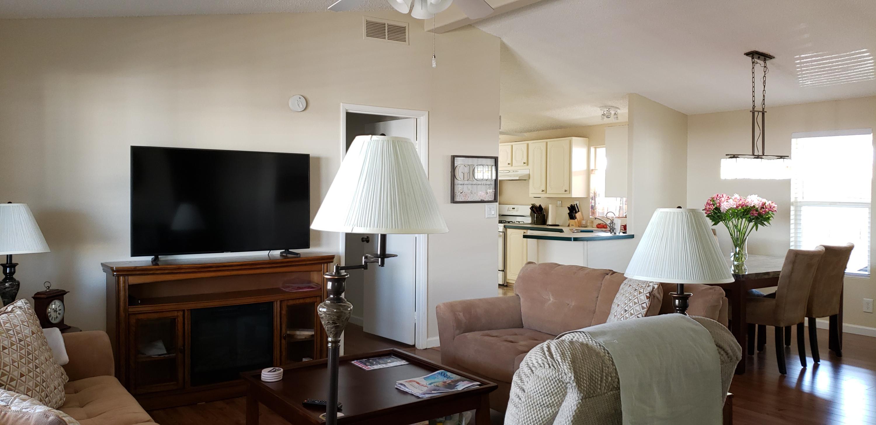 301 South Signal Butte Road, Unit 705 Apache Junction, AZ 85120 - Photo 7 of 50 a living room with furniture and a flat screen tv