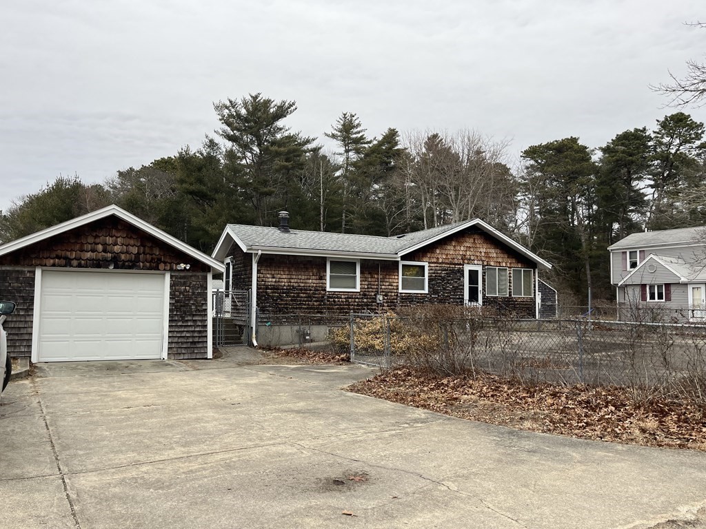 23 Crooked River Road Wareham, MA 02571 - Photo 1 of 11 a front view of a house with a yard and garage
