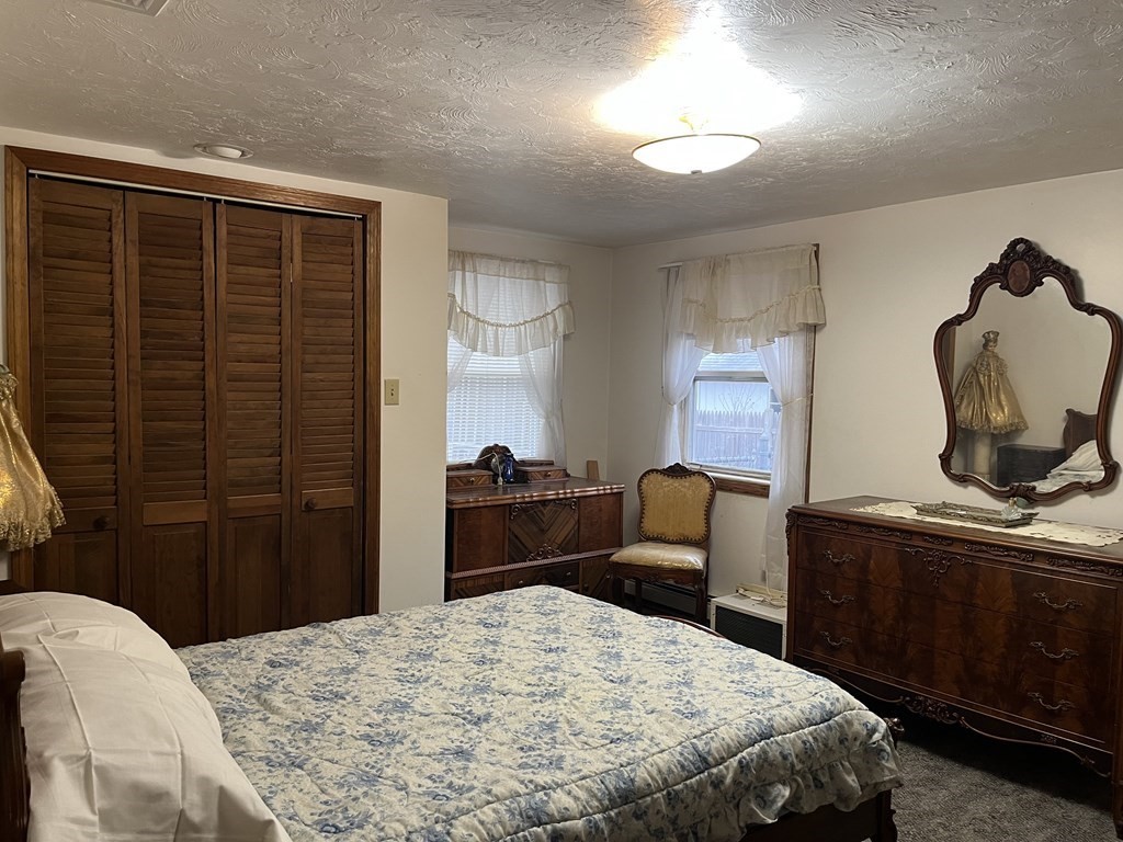23 Crooked River Road Wareham, MA 02571 - Photo 4 of 11 a bedroom with a bed and wooden floor