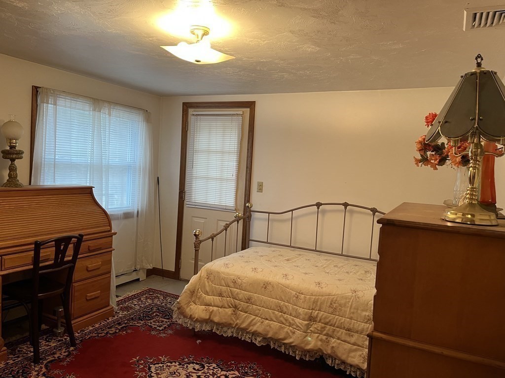 23 Crooked River Road Wareham, MA 02571 - Photo 5 of 11 a bedroom with a bed and a chandelier