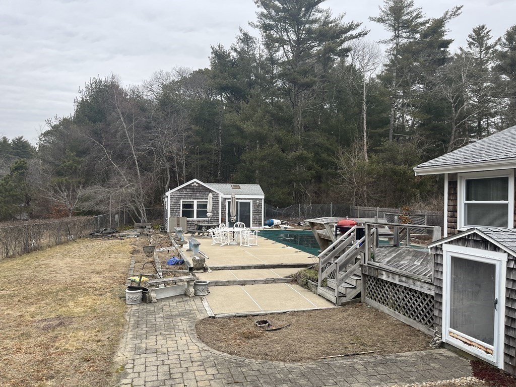 23 Crooked River Road Wareham, MA 02571 - Photo 8 of 11 a house with a bench and trees in the background