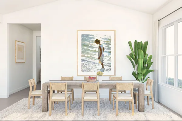 a dining room with furniture a potted plant and a window