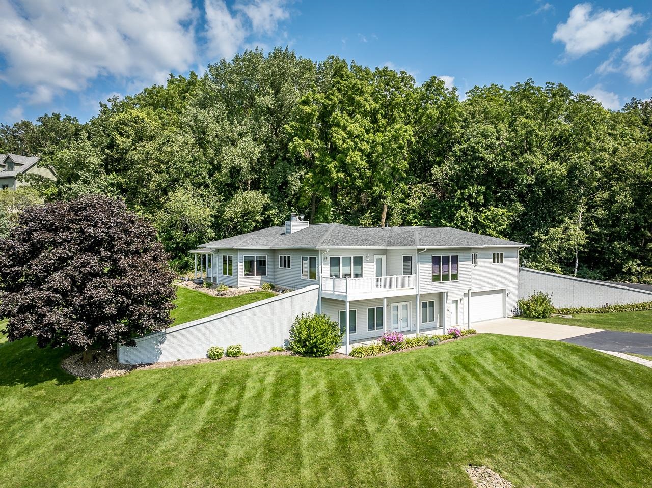 22781 Zier Road Lake Carroll, IL 61046 - Photo 1 of 58 a front view of a house with a garden