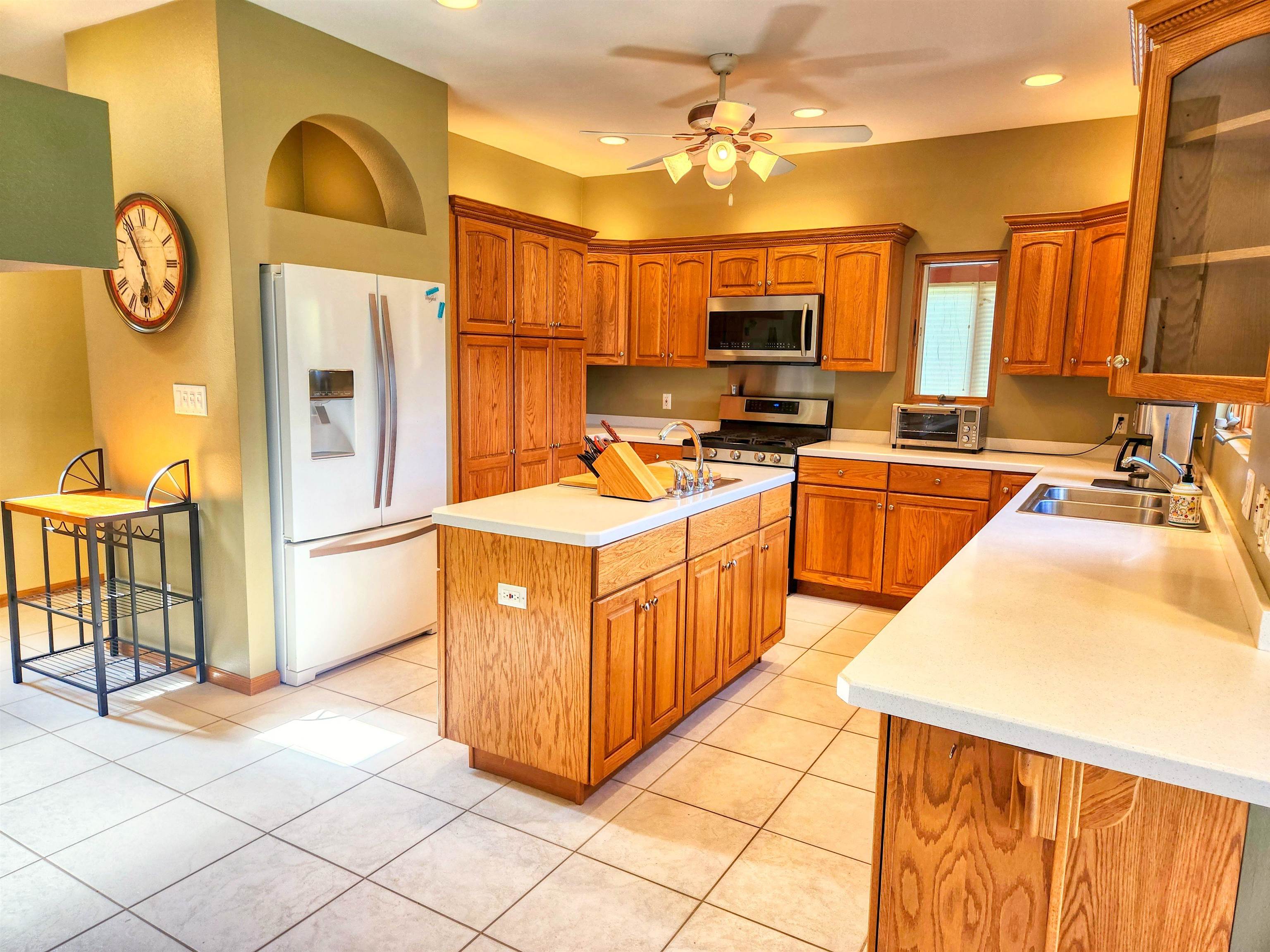 22781 Zier Road Lake Carroll, IL 61046 - Photo 11 of 58 a large kitchen with stainless steel appliances granite countertop a stove a sink dishwasher and a refrigerator with wooden floor