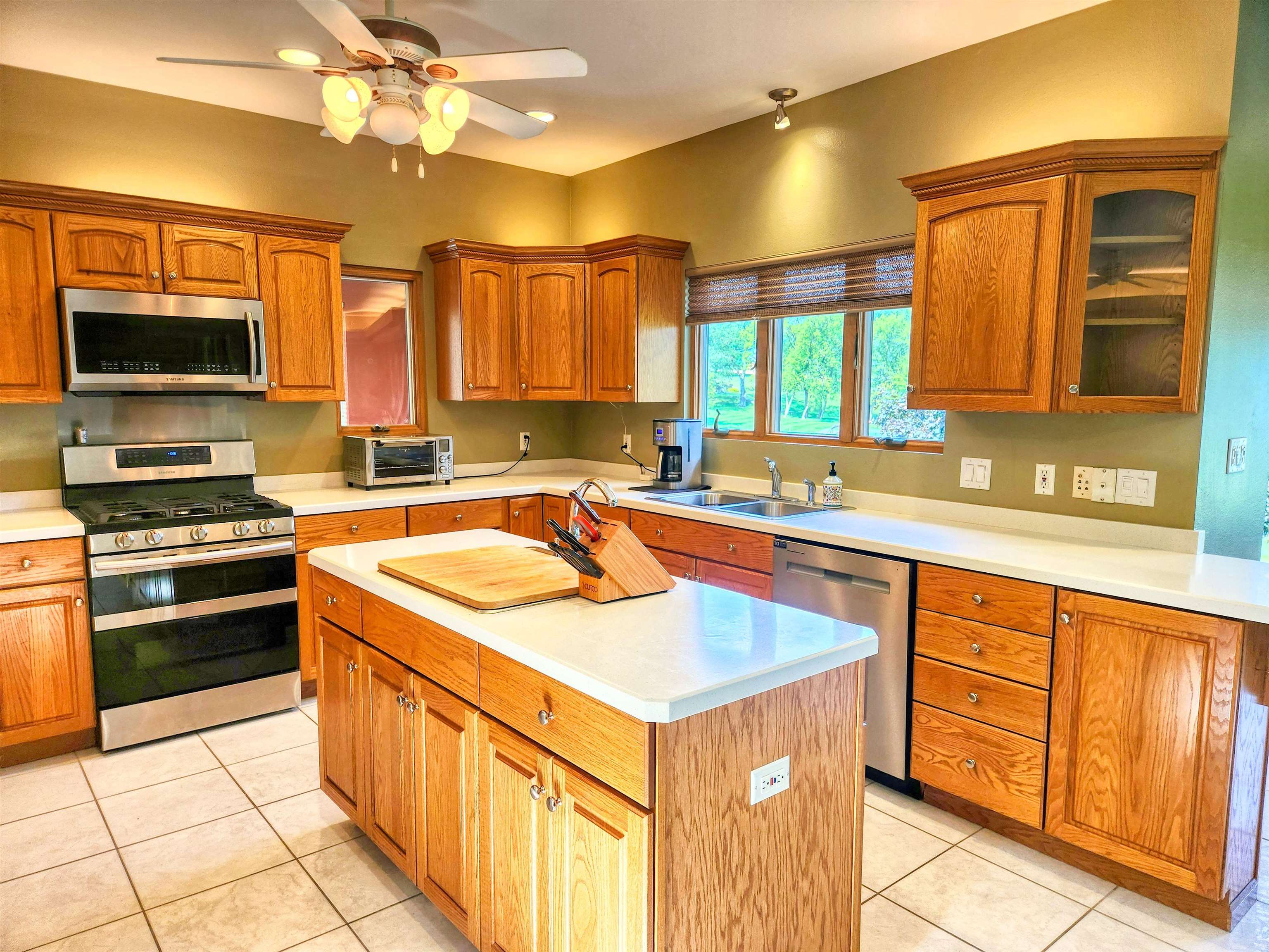 22781 Zier Road Lake Carroll, IL 61046 - Photo 12 of 58 a kitchen with stainless steel appliances granite countertop a sink stove and refrigerator