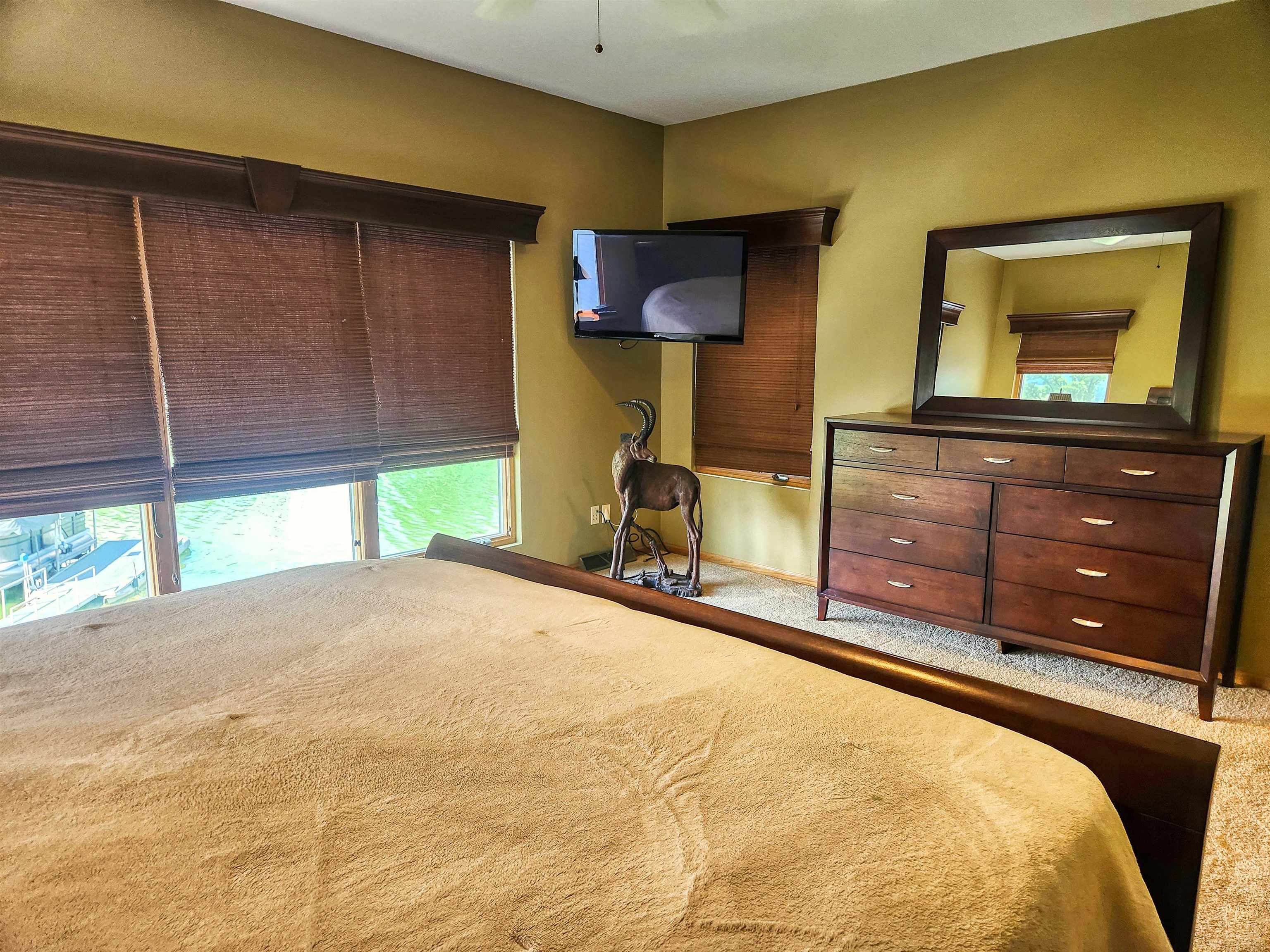 22781 Zier Road Lake Carroll, IL 61046 - Photo 19 of 58 a bedroom with a bed and a dresser