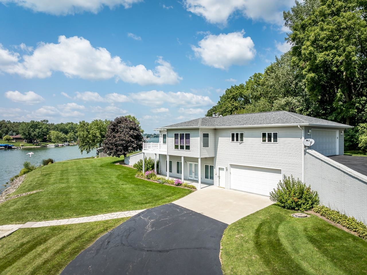 22781 Zier Road Lake Carroll, IL 61046 - Photo 53 of 58 a front view of a house with a garden and lake view
