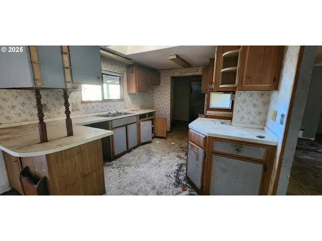 a kitchen with stainless steel appliances kitchen island granite countertop a sink and cabinets