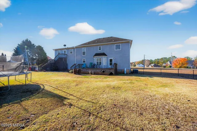 a front view of a house with a yard and potted plants