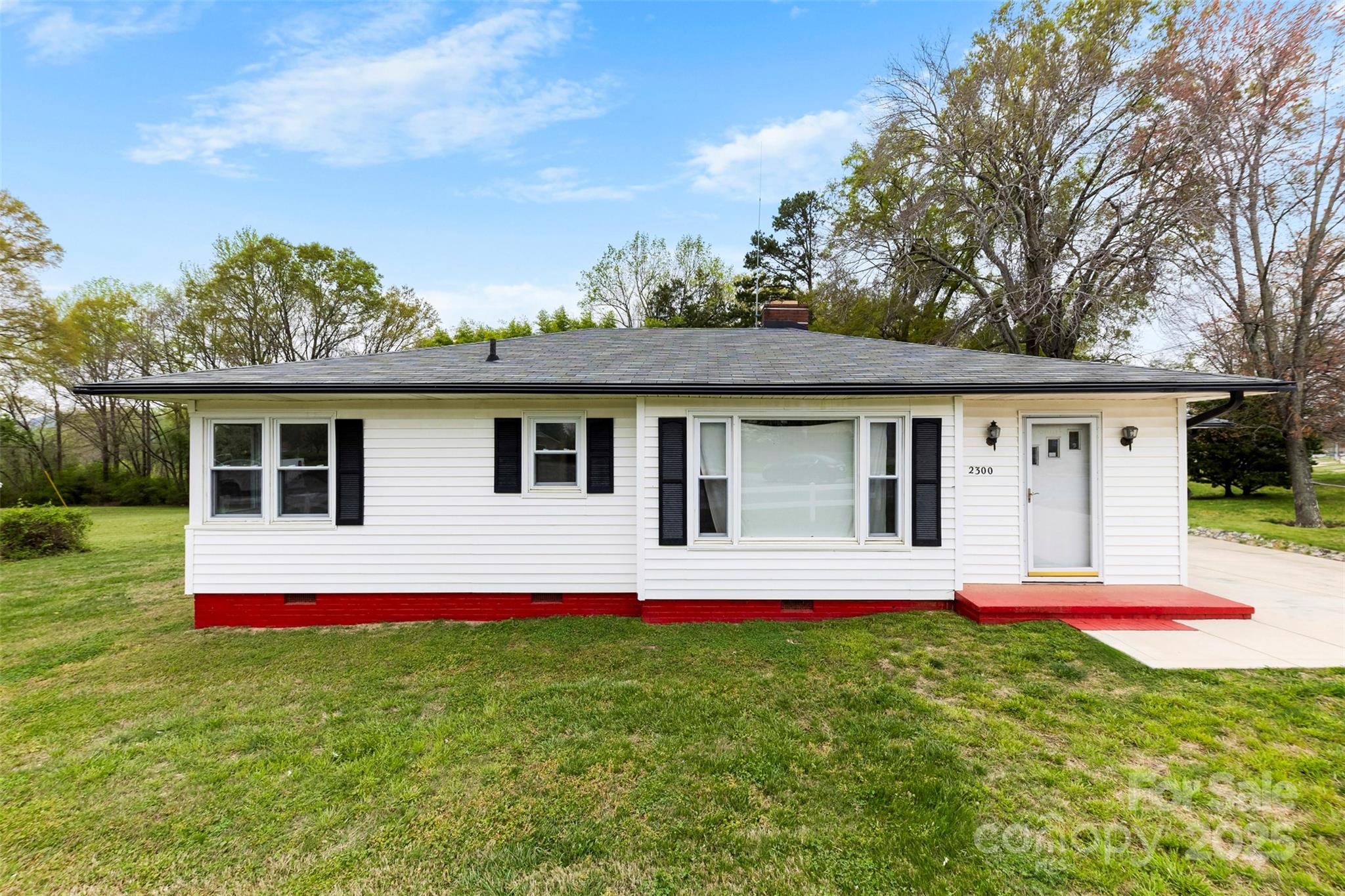 a front view of house with yard and green space