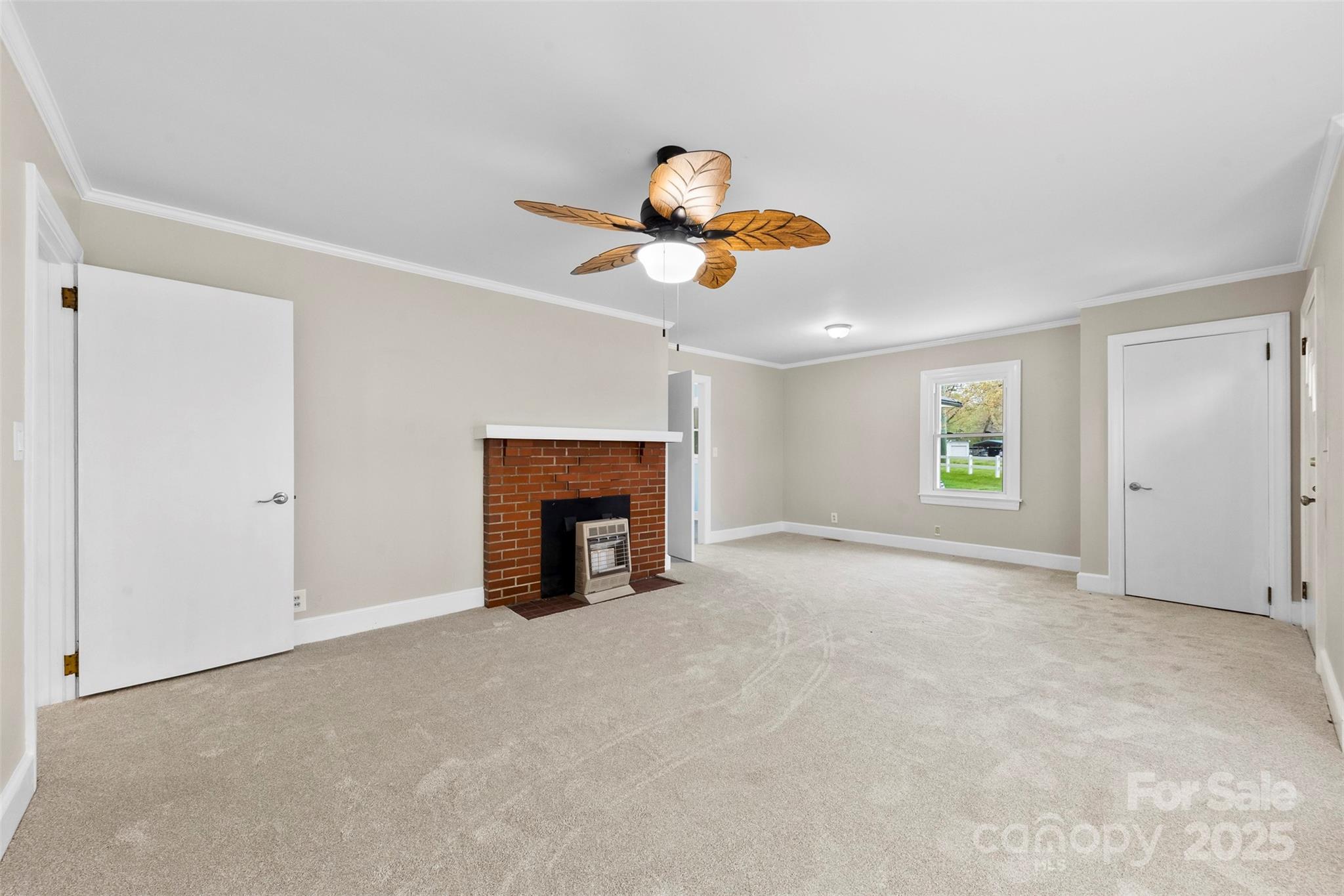 2300 Linwood Road Gastonia, NC 28052 - Photo 6 of 23 a view of an empty room with a fireplace and a window