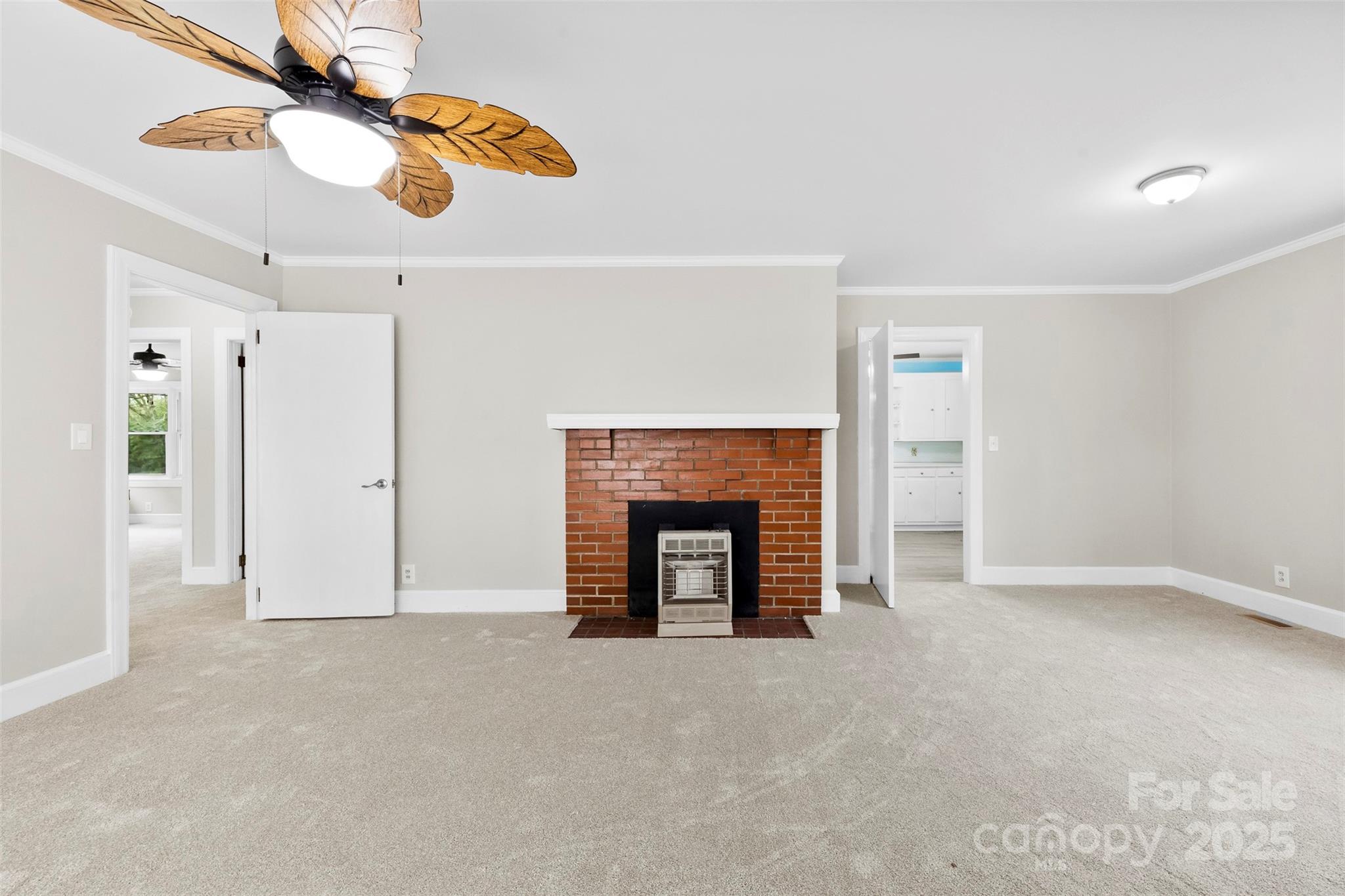 2300 Linwood Road Gastonia, NC 28052 - Photo 7 of 23 a view of an empty room with fan and kitchen view