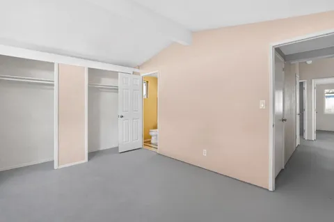 a kitchen with granite countertop a stove top oven microwave and cabinets