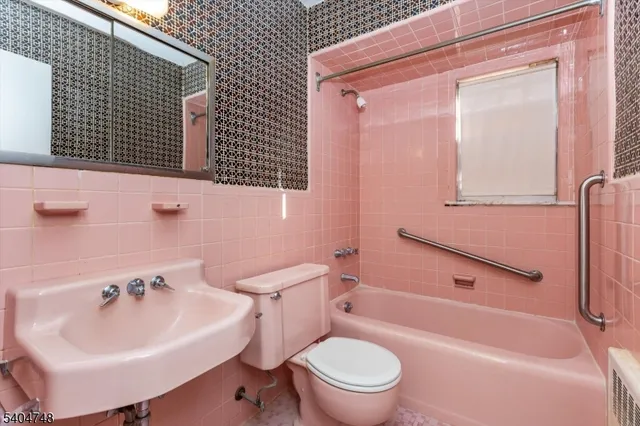a bathroom with a sink toilet tub and shower