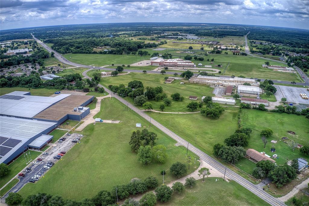 221 Maple Street Commerce, TX 75428 - Photo 10 of 19 an aerial view of a house with a garden and lake view