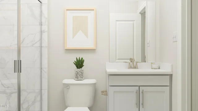a bathroom with a sink mirror and toilet
