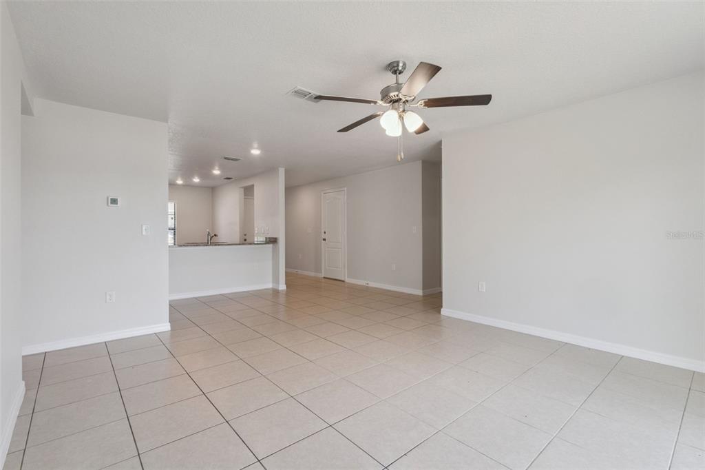 1613 Orne Street Mascotte, FL 34753 - Photo 14 of 31 a view of an empty room and chandelier fan