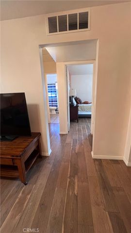 a bedroom with a bed and a lamp on the dresser