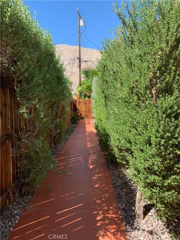 a view of a pathway covered with wooden fence