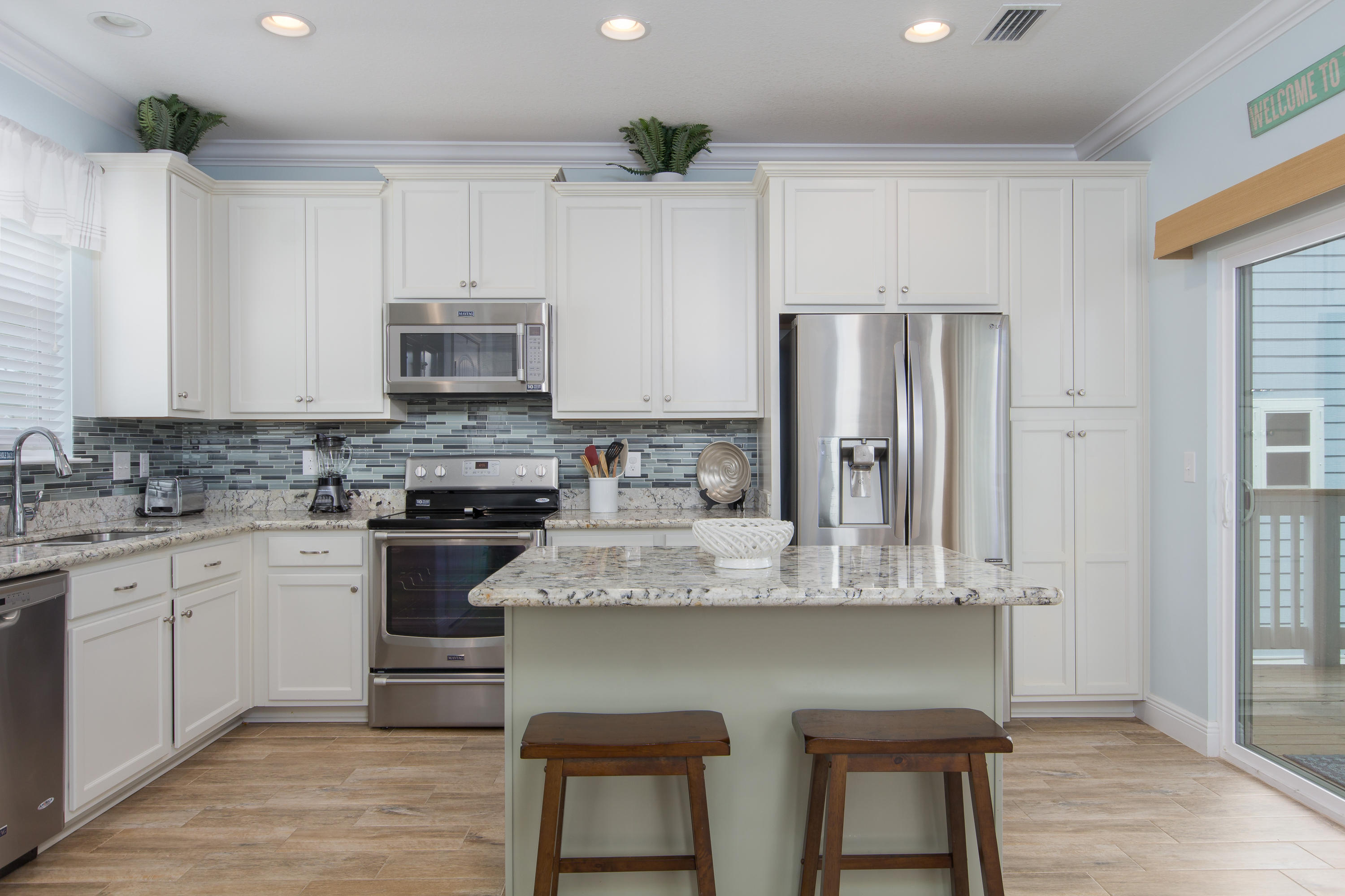 164 Sandpine Loop Inlet Beach, FL 32461 - Photo 5 of 24 a kitchen with stainless steel appliances granite countertop a white cabinets and a refrigerator