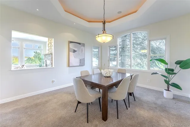 a dining room with furniture a chandelier and window