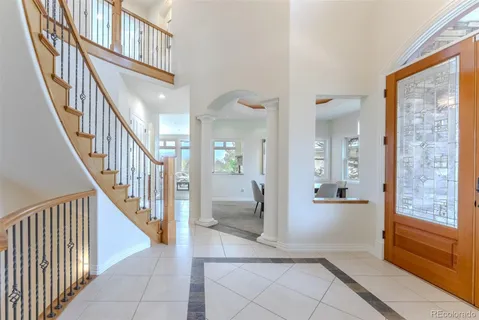 a view of an entryway with wooden floor and a livingroom view
