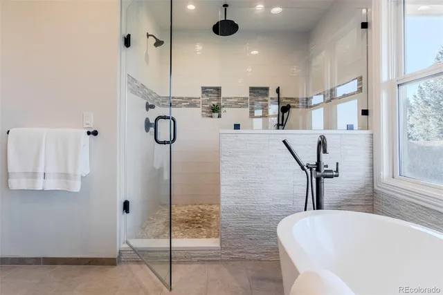 a bathroom with a tub sink and mirror