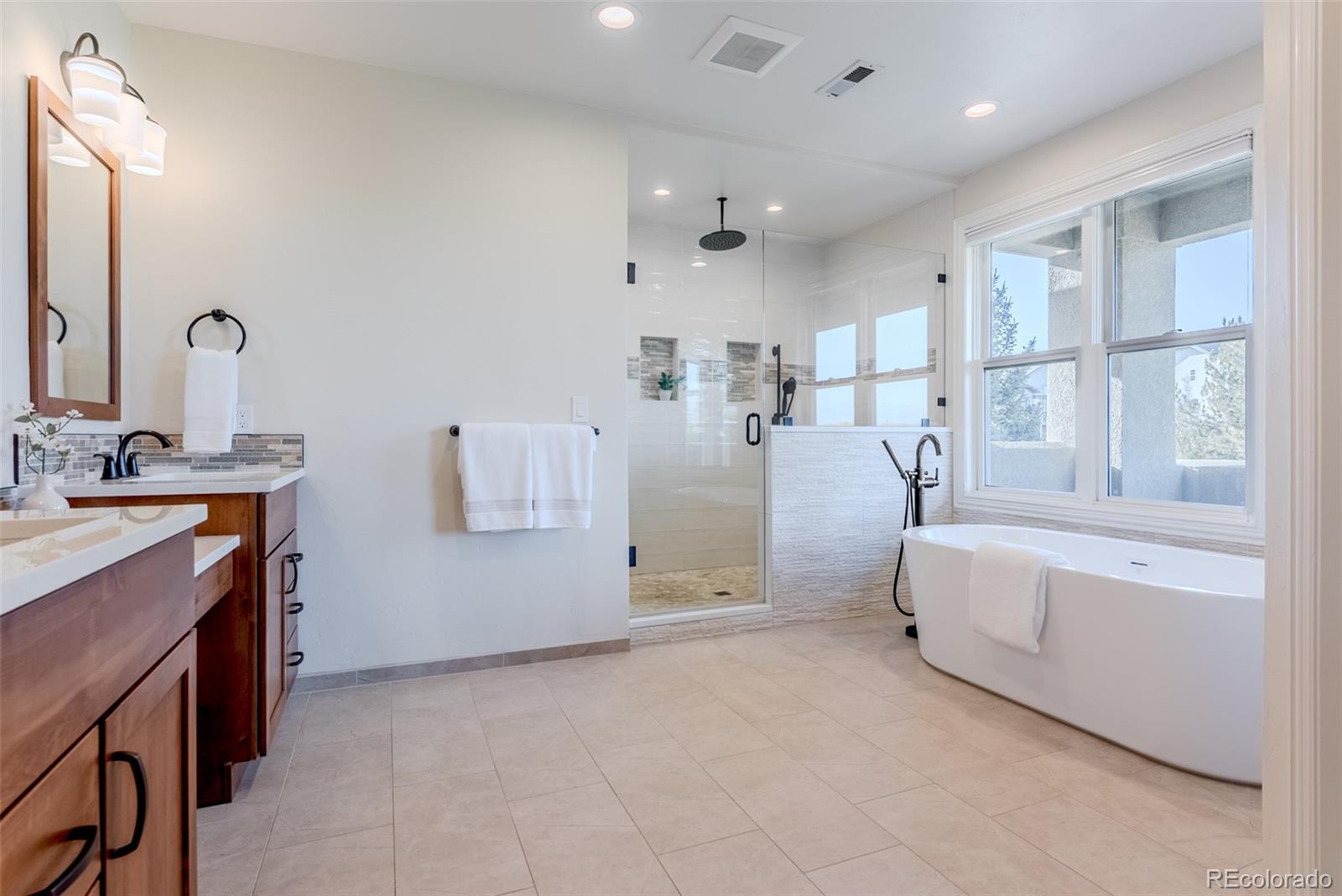 768 Bridger Point Lafayette, CO 80026 - Photo 23 of 50 a bathroom with a tub sink and mirror