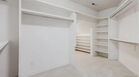 a bathroom with a granite countertop toilet sink and mirror