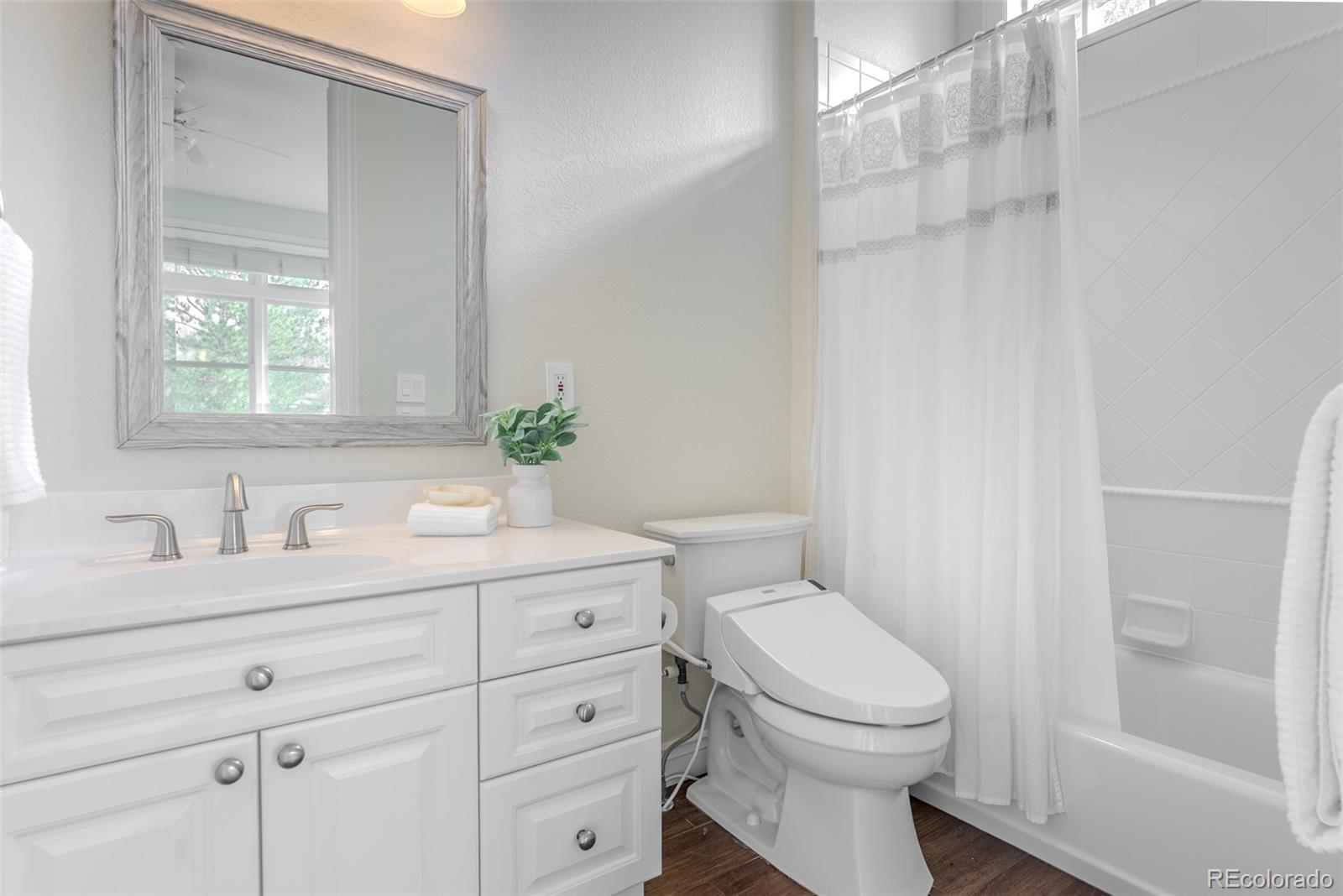 768 Bridger Point Lafayette, CO 80026 - Photo 31 of 50 a bathroom with a granite countertop toilet sink and mirror