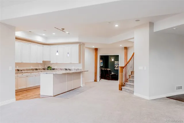 an empty room with furniture and a flat screen tv