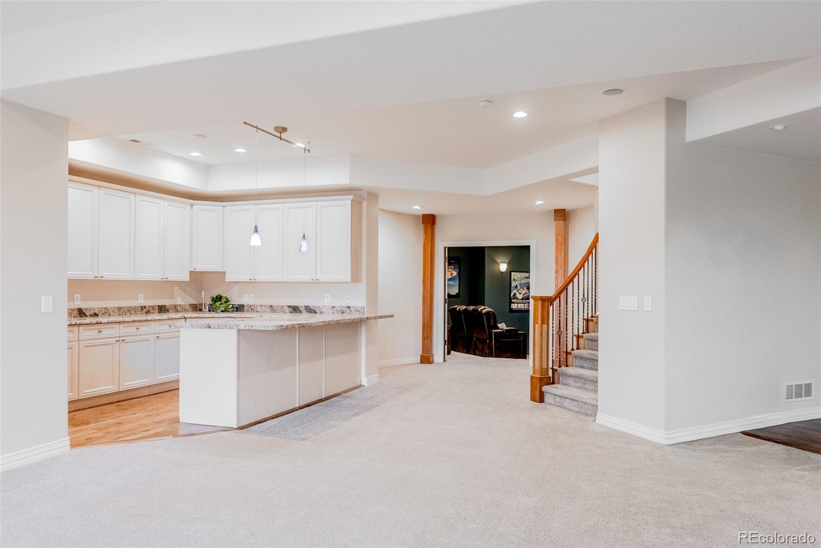 768 Bridger Point Lafayette, CO 80026 - Photo 32 of 50 a large white kitchen with granite countertop a sink and cabinets
