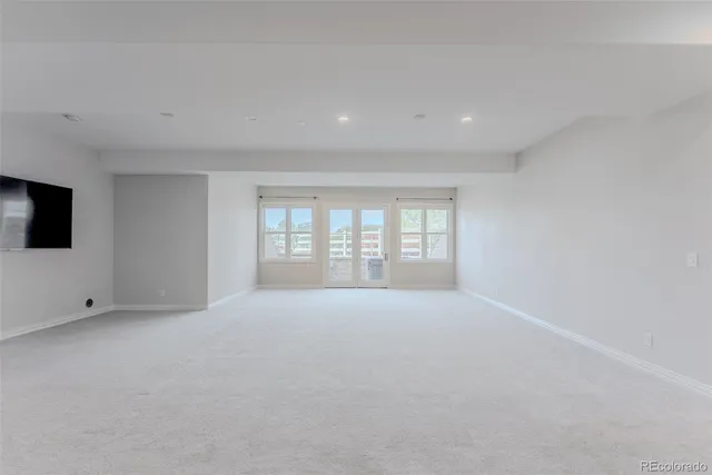 a bathroom with a granite countertop sink a toilet and a mirror
