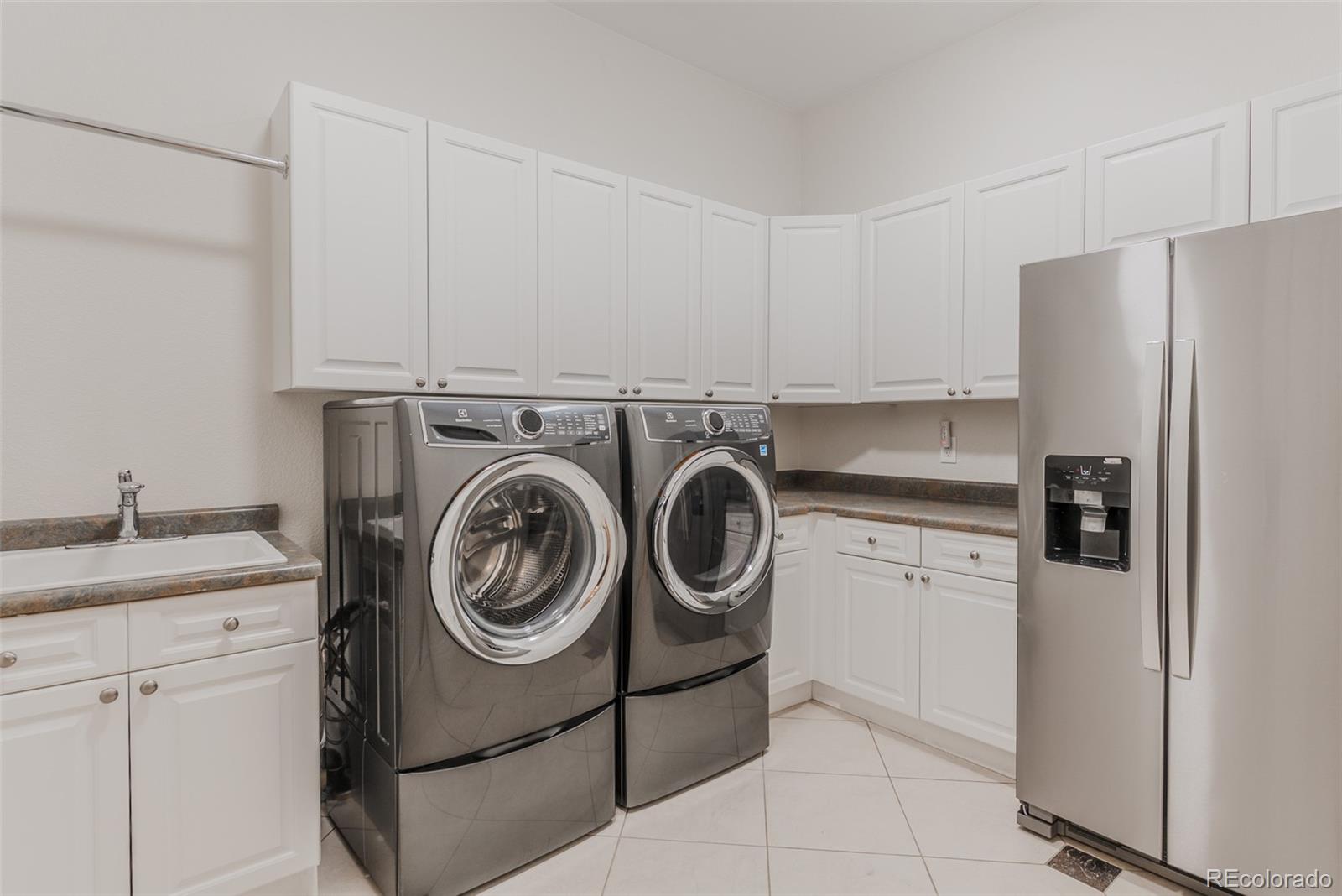 768 Bridger Point Lafayette, CO 80026 - Photo 40 of 50 a utility room with sink dryer and washer