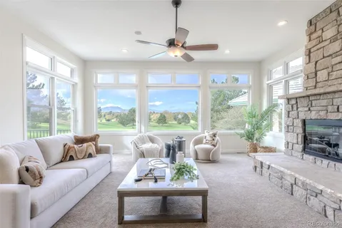 a living room with furniture large window and flat screen tv
