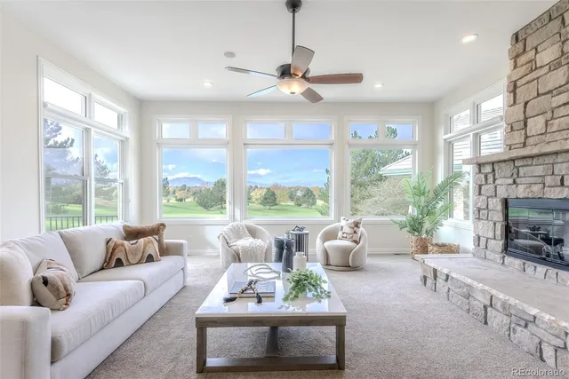 a living room with furniture large window and flat screen tv